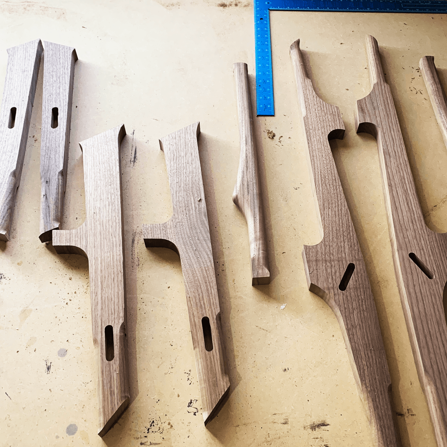 Milled walnut components laid out before assembly